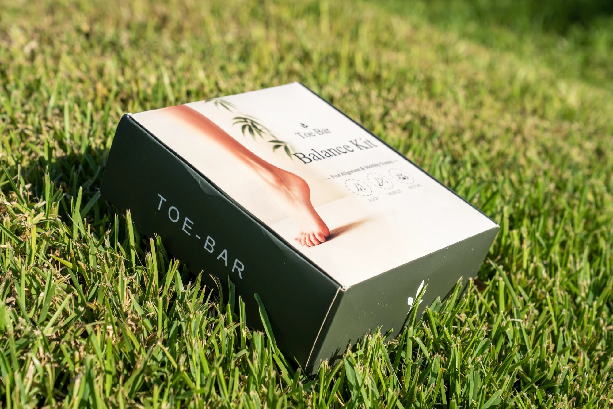 Toe-Bar Balance Kit box angled view on grass showing front and side TOE-BAR branding